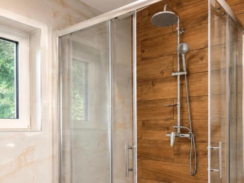 a shower with a glass door in a bathroom at Chata Medvedík in Turík