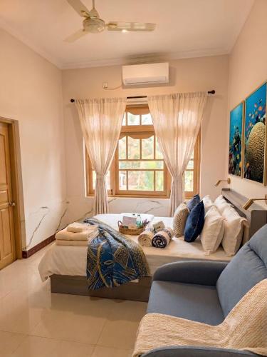 a large room with two beds and a couch at Ocean Stay & Dive in Fenfushi