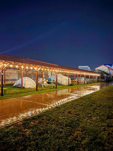 a building with a lot of lights on it at Relax by the Sea Camping next to Nibiru in Costinesti