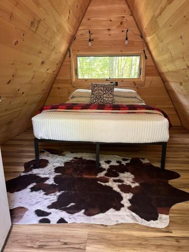 a bedroom with a bed in a wooden attic at White Mountains A-Frame Off-Grid Stars Firepit in North Lovell