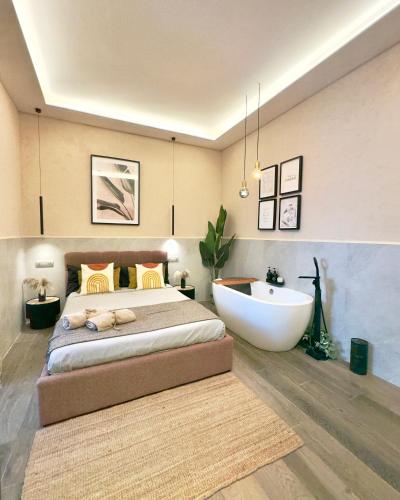 a bedroom with a large bed and a bath tub at Falco Deluxe Home - Naples Airport & Town in Naples