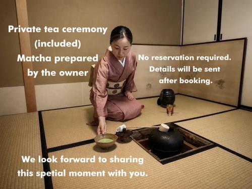 a young girl sitting on the floor in a kitchen cooking at Ryokan Tori in Kyoto