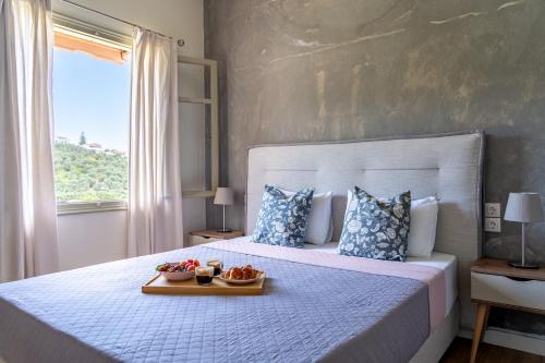 a bedroom with a bed with two bowls of fruit on it at Flower in Skiathos