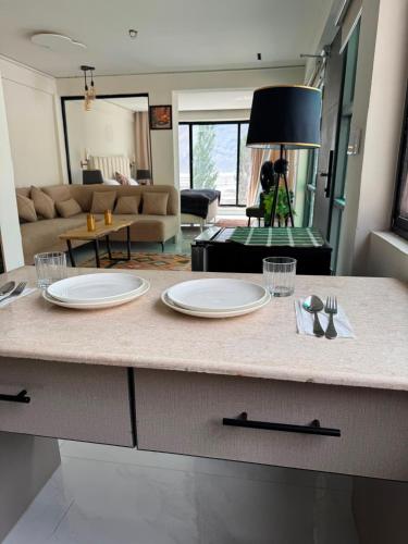 a kitchen with two plates on a counter in a living room at Lamhay Private lodges in Skardu