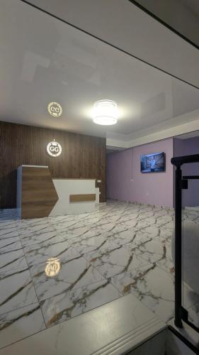 a lobby with a large marble floor and a wall at hotel G&G in Tsaghveri