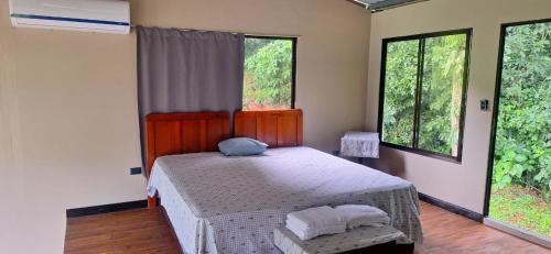a bedroom with a bed with two pillows on it at Bosque Alto Lodge in Platanal