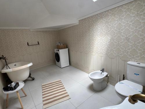 a bathroom with a sink and a toilet and a washing machine at Dare apartments 1 in Giurgiu
