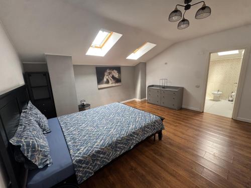 a bedroom with a bed and a wooden floor at Dare apartments 1 in Giurgiu