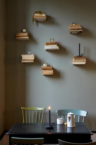 a table with two chairs and a candle on a wall at Le Boutik Hotel in Annecy