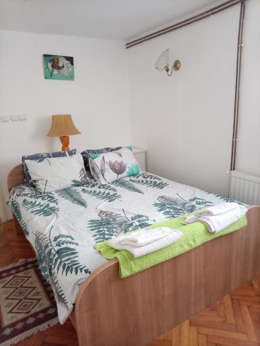 a bedroom with a bed with towels on it at Dana in Trnava