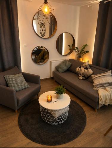 a living room with a couch and a table at Casa NICOLE in Malá Morávka