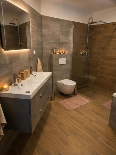 a bathroom with a sink and a toilet and a shower at Casa NICOLE in Malá Morávka