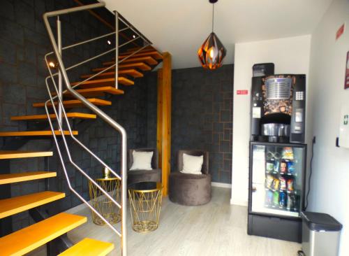 a room with a spiral staircase and a couch at Pinhal Litoral in Marinha Grande