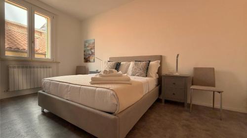 a bedroom with a bed and a chair and a window at Vista Duomo Foligno in Foligno