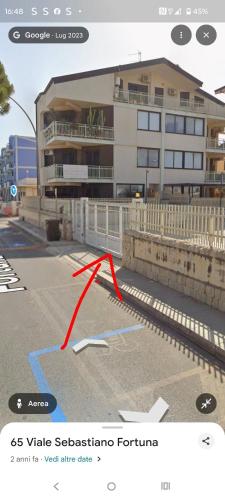 a red arrow on a street in front of a building at Casa Marsilla in Marzamemi