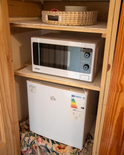 a microwave sitting on top of a refrigerator at Skyevale in Portree