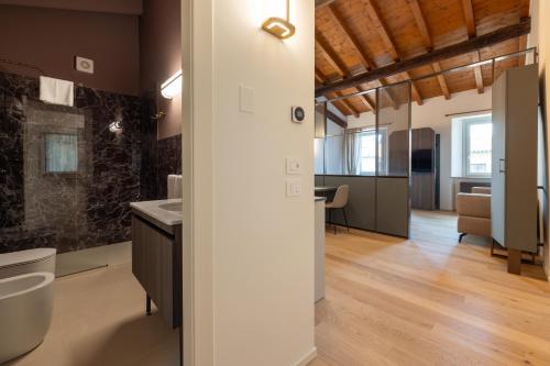 a bathroom with a sink and a toilet in a room at Ca Moroni Collection in Bergamo