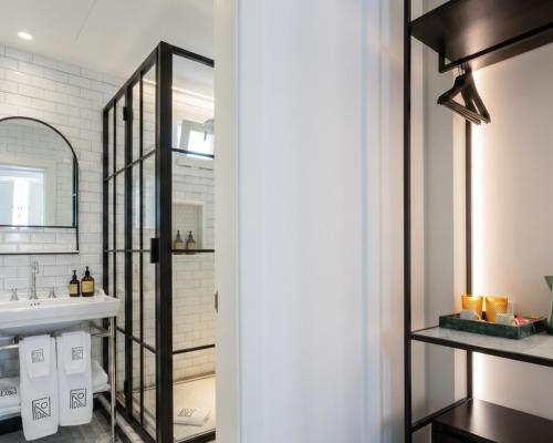 a bathroom with a sink and a mirror at La Fonda Heritage Hotel Luxury, Relais & Châteaux in Marbella