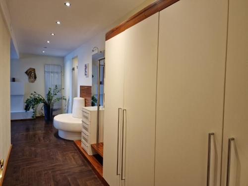 a bathroom with a toilet and a white cabinet at HOTEL MARIA in Gramatneusiedl