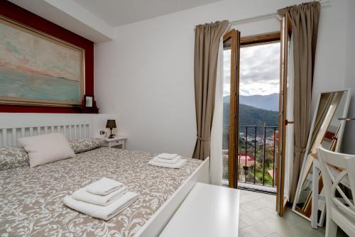 a bedroom with a bed and a large window at N'haidea - AgriFarm e B&B in Lettere