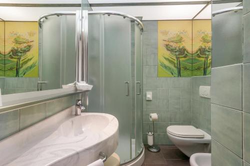 a bathroom with a shower and a sink and a toilet at Hotel Barcarola 2 in Marina di Campo