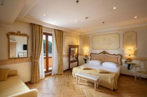 a bedroom with two beds and a couch at Hotel Villa San Pio in Rome