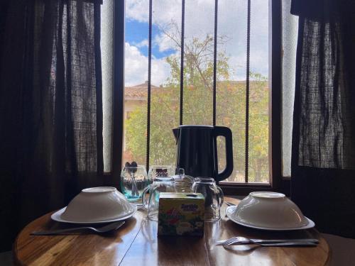 a table with two dishes on it with a window at El Nido in Samaipata