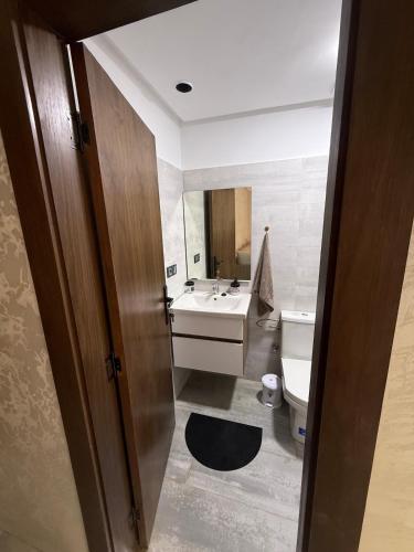 a bathroom with a sink and a toilet and a mirror at Appartement - centre ville Ifrane in Ifrane