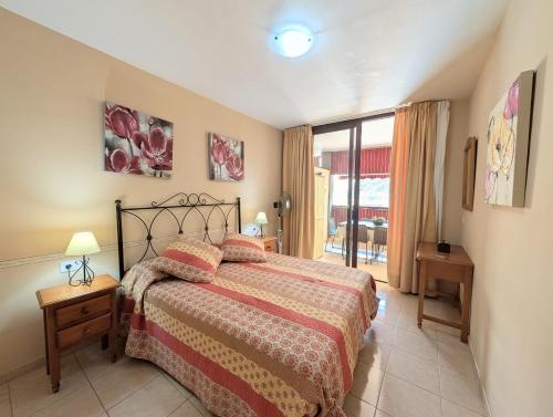 a bedroom with a bed and a large window at CHC - Olivia Sunset II in Puerto de Santiago