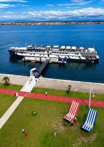 a large boat is docked at a marina at Costa do Sal Hotel Boat Lounge in Aveiro