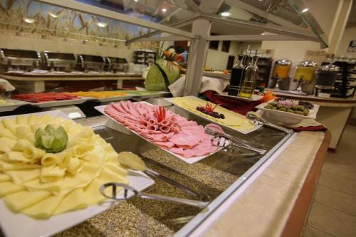 a kitchen with many plates of food on a counter at Xima Exclusive Cusco in Cusco