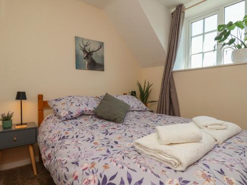 a bedroom with a bed with a deer on it at 4 Lilac Cottages in Whitby