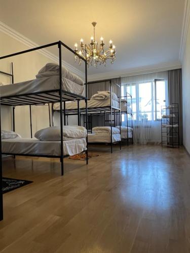 a room with four bunk beds and a chandelier at Hostel Velvet Vouge in Yerevan