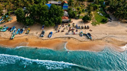 an aerial view of a beach with a group of boats at Sheen Coast Beach Cabana in Nilaveli