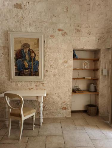 a room with a table and a painting on the wall at TRULIVO in Monopoli