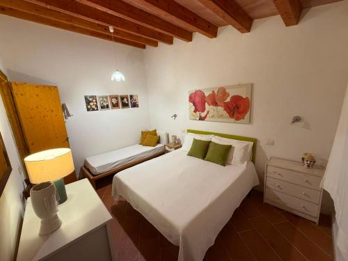 a bedroom with a bed and a nightstand and a bed sidx sidx sidx sidx at Country house La Virgy with exclusive pool and sea view in Avola