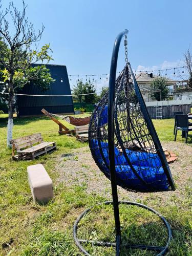 a swing in a yard with at Kakhaberi Cottages in Stantsiya Batumi-Passazhirskaya