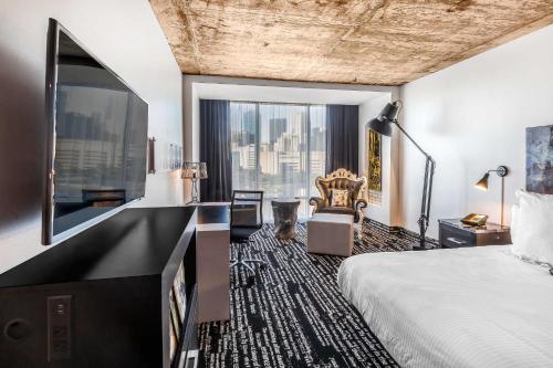 a hotel room with a bed and a large window at Lorenzo Hotel Dallas, Tapestry Collection by Hilton in Dallas