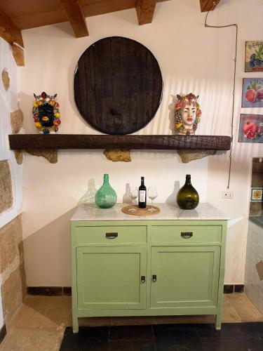 a bathroom with a green cabinet and a mirror at Country house La Virgy with exclusive pool and sea view in Avola