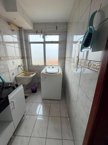 a small bathroom with a sink and a toilet at Apartamento Inteiro Foz do Iguaçu Prox Rodoviaria in Foz do Iguaçu