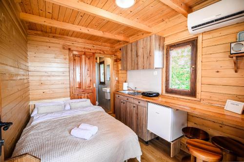 a bedroom with a bed in a wooden cabin at Tiny Panorama Cottages in Kamnik