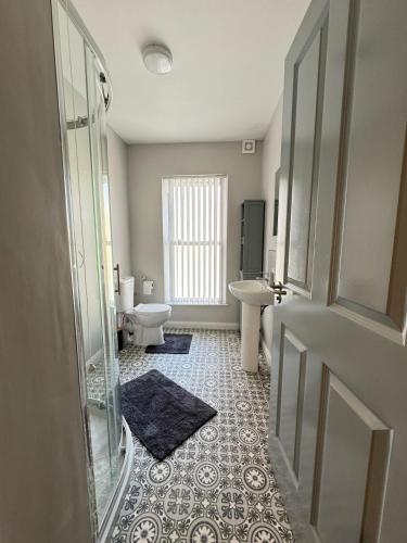 a bathroom with a toilet and a sink at Ogle Street 1-Bed Apartment in Armagh