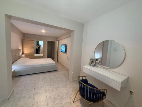 a bedroom with a bed and a large mirror at Thomi's house. in Yerakiní