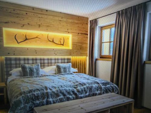a bedroom with a bed with a wooden wall at Casa Belluno in Belluno