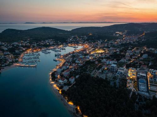 an aerial view of a harbor at night at Magnificent Murter Villa Villa Royal 4 Bedrooms Sea Views & Private Pool in Jezera