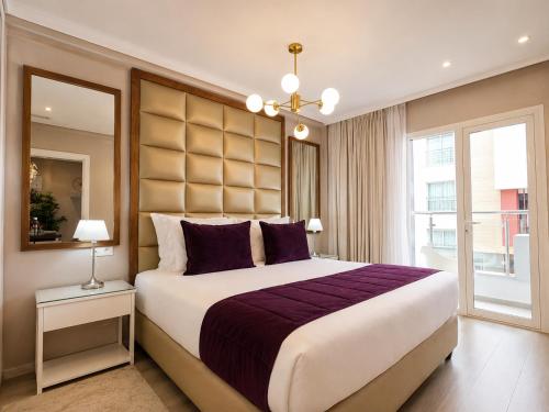 a bedroom with a large bed and a large window at RENT-INN Suites Hotel in Rabat