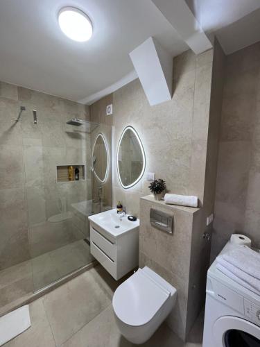 a bathroom with a toilet and a shower and a sink at Refresh apartman in Belgrade