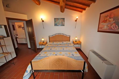 a bedroom with a large bed with two tables at Agriturismo Tiberio in Penna