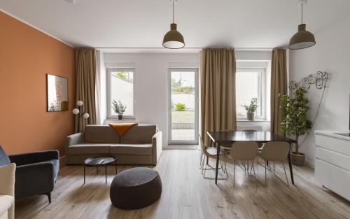 a living room with a couch and a table at Limehome Chemnitz Hartmannstraße in Chemnitz