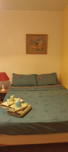 a bed with a blanket and towels on it at Chambre très calme in Montélimar